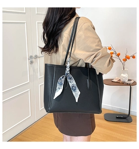Chic black lychee grain tote bag with floral scarf accessory shown on shoulder