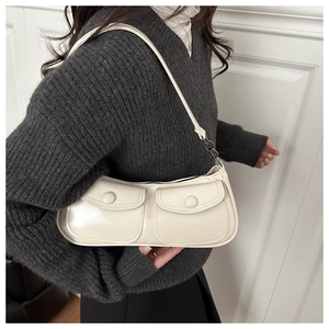 Détail d'un sac sous les bras crème vintage avec deux poches frontales en cuir PU lisse