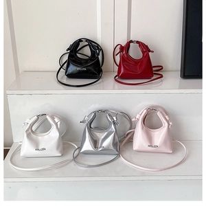 Five assorted patent leather mini crossbody bags in black, red, white, silver, and pink