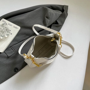 Minimalist white ostrich embossed crescent bag with gold chain and crossbody strap