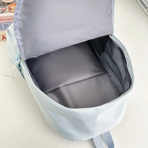 Light blue minimalist backpack with spacious main compartment and dark grey inner lining