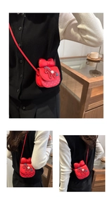 Detail view of red girls' crossbody bag with bow and pony embroidery shown on a model