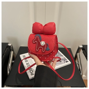 Detail of red cartoon pony crossbody bag with bow and polka dots for girls