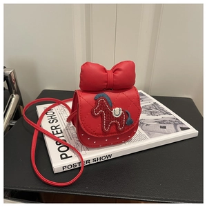 Detail of red quilted faux leather child crossbody bag featuring cute pony embroidery