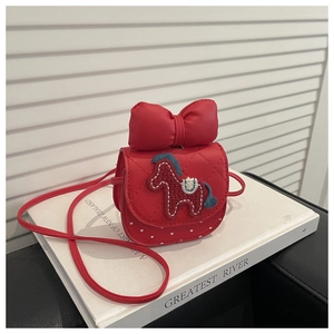 Detail of red mini crossbody bag with quilted pattern, horse embroidery and bow decoration