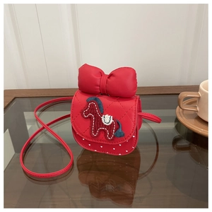 Close-up of red mini crossbody bag with a large bow and cute pony embroidery