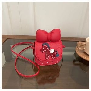 Detail of red quilted child's crossbody bag with pony embroidery and large top bow