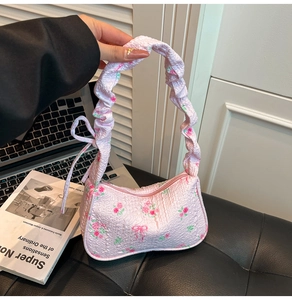 Detailed shot of pink floral cloud bag with rose patterns and bow accent