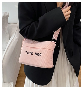 Pink corduroy crossbody bag with TOTE BAG embroidery and stylish woven wide strap