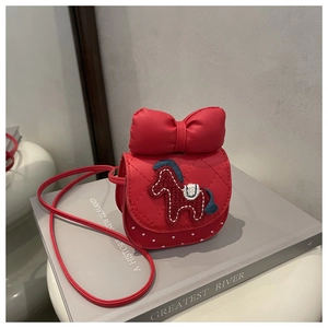 Macro shot of red quilted faux leather child bag with horse embroidery and big bow