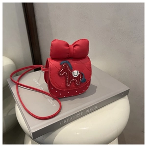 Detail of red quilted PU leather crossbody bag with horse embroidery and big bow