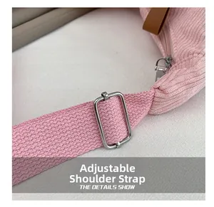 Detail of adjustable pink corduroy strap with silver buckle and leather accents