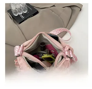 Pink corduroy crossbody bag featuring three zipper compartments for high capacity storage