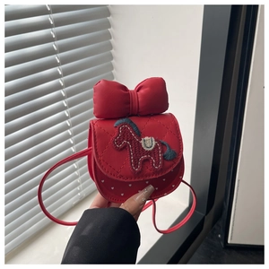 Close-up of red girl's mini purse with horse embroidery and large bow detail