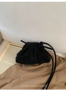 Minimalist black suede cloud handbag with elegant gathers and thin drawstring strap