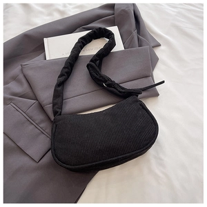 Close-up of black corduroy hobo bag with pleated strap and soft textured crescent design