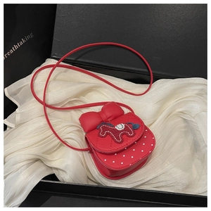 Macro view of red girl's bag with bow and horse embroidery in a luxury gift box