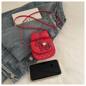 Detailed view of red mini crossbody bag with horse embroidery and a large bow decor
