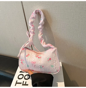 Detail view of pink rose floral shoulder bag with trendy pleated scrunchie handle
