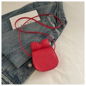 Detail of red plaid saddle bag for girls with large bow and quilted leather texture
