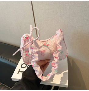 Detailed macro view of pink floral seersucker handbag with ribbon bow decoration