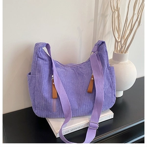 Detailed view of purple corduroy tote with multi-pockets and adjustable strap