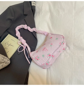 Close-up of floral fabric bag with pink rose patterns and cute bow knot detail