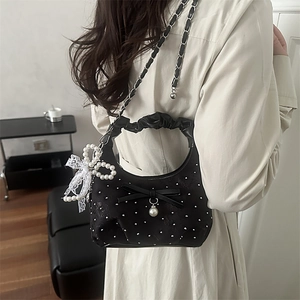 Elegant black pleated handbag with pearl dots, bow detail and silver chain strap