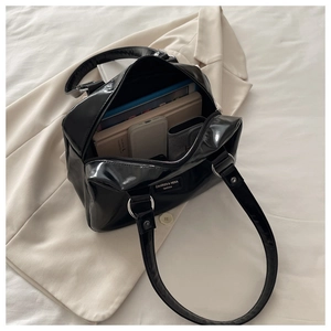 Spacious interior of the black oil wax leather tote holding a tablet and notebook