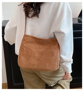 Detail showing back view of large brown corduroy tote bag with double front pockets