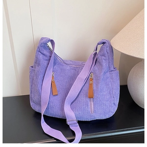 Detailed macro of lavender corduroy tote bag with multiple pockets and adjustable strap