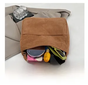 Detail view of brown corduroy tote bag showing spacious interior with daily essentials