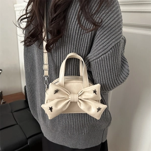 Beige mini crossbody bag with oversized bow and metal star studs for stylish women