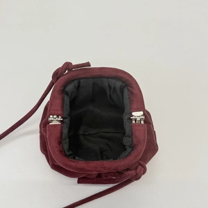 Vintage burgundy suede shell bag with silver metal clasp closure and long strap