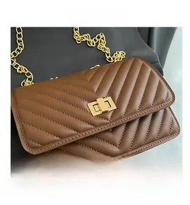 Detailed close-up of brown quilted faux leather handbag with gold twist lock and V-stitch