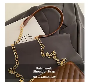 Detailed close-up of brown quilted leather shoulder bag with gold metal chain strap