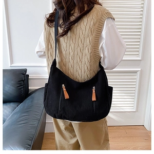 Black corduroy dumpling bag with large capacity and decorative brown leather zipper pulls