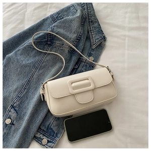 Minimalist beige leather flap bag with square buckle detail on white fabric background
