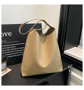 Detailed shot of large capacity khaki tote bag with fashion lettering and wide shoulder strap