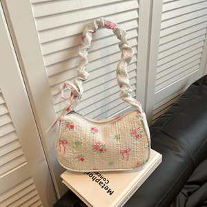 Sweet floral white underarm bag with pink roses, bow patterns, and ruffled bubble strap