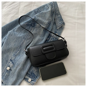 Detailed view of black flap crossbody bag showing size capacity with mobile phone reference