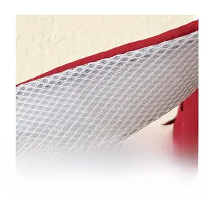 Macro shot of breathable white honeycomb mesh on red backpack shoulder straps for comfort