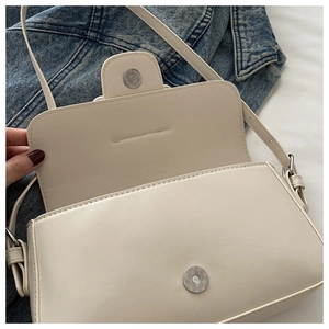 Close-up of beige PU leather bag showing magnetic closure and interior structure