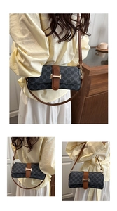 Close-up of monogram fabric crossbody bag with leather trim and gold H-clasp hardware