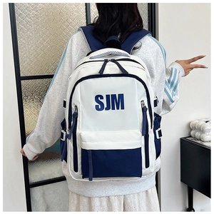 Back view of a large capacity blue and white color-block backpack with SJM lettering