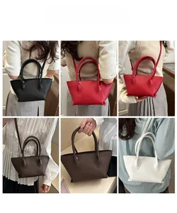 Detail showing the lychee grain texture and minimalist design of multi-color tote bags
