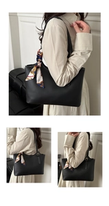 Detail of black tote bag featuring white contrast stitching and baroque print silk scarf