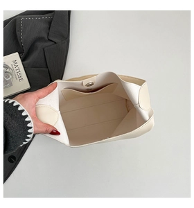 Macro detail of the cream tote bag interior showing magnetic closure and inner pocket