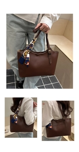 Detail of dark brown tote bag with decorative floral scarf and gold metal hardware adjustment