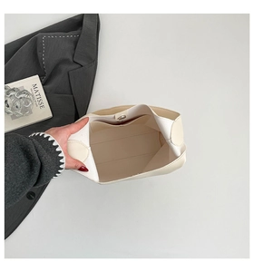 Top view of cream tote bag interior showing spacious main compartment and magnetic clasp
